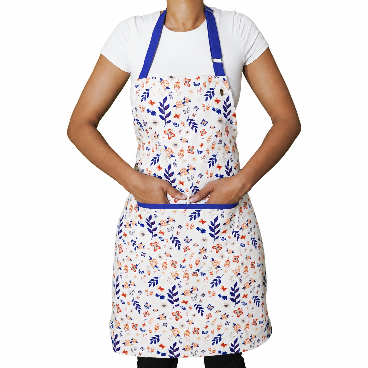 Model wearing the floral apron with blue neck and pocket trim