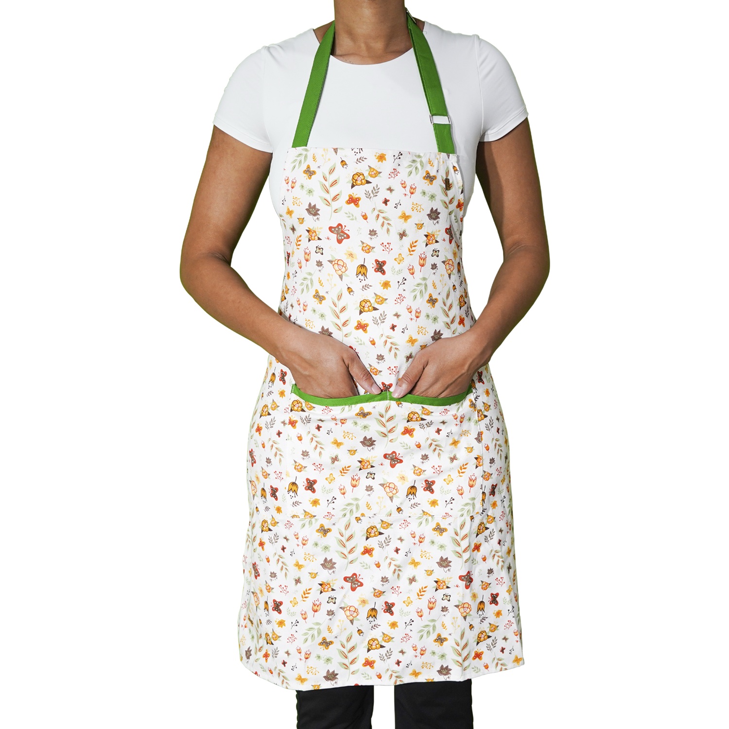 Model wearing the floral apron with green neck and pocket trim
